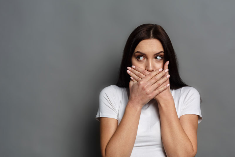 Dental Patient Hiding Her Missing Teeth in Her Mouth