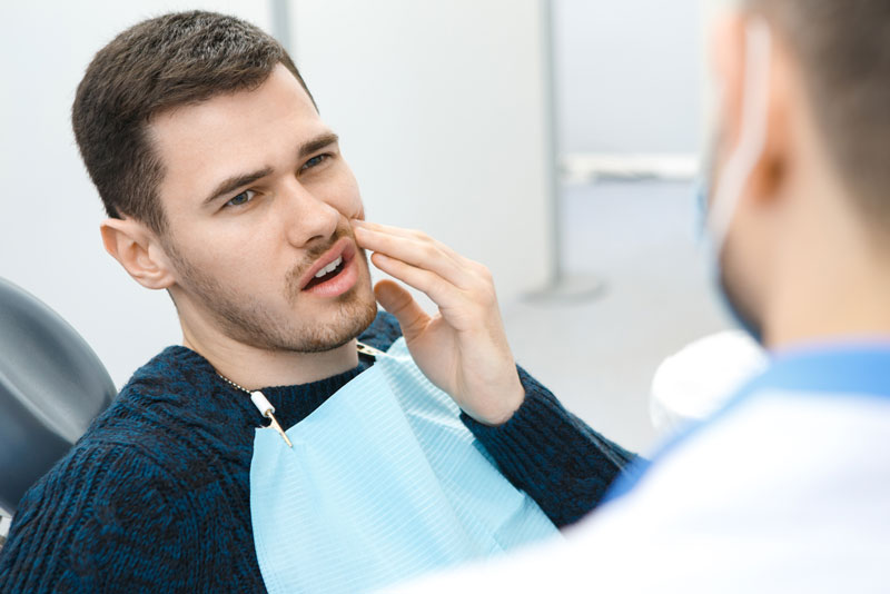 Dental Patient Suffering From Mouth Pain On A Dental Chair, In St. Charles, IL