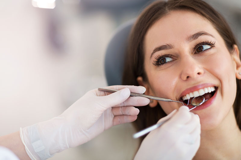 patient getting their teeth looked at by a dentist.