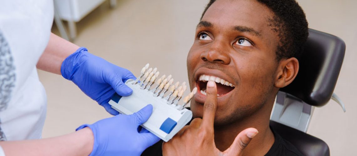 Dental patient pointing to teeth as the dentist makes the process of treatment in dental clinic.
