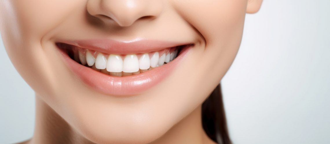 A close-up photo a girls perfectly straight and white smile after cosmetic dentistry