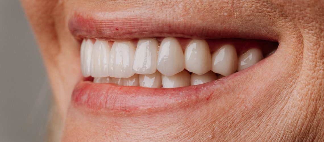 A diverse family is in the waiting room of a bright and modern dental office in California, there are palm trees visible through the window. The text on the wall says 