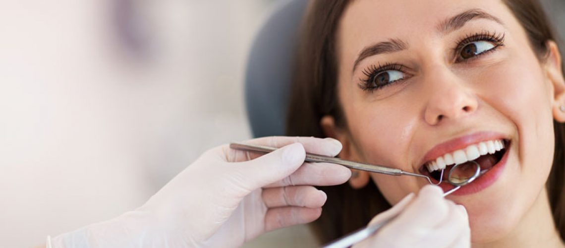 patient getting their teeth looked at by a dentist.